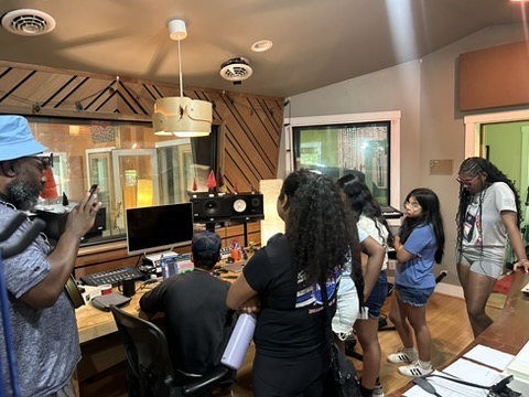 A group in a music studio