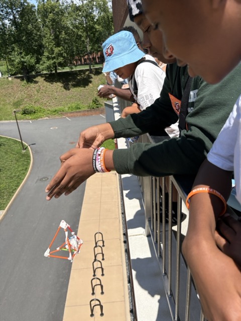 Students testing experiments off of a balcony