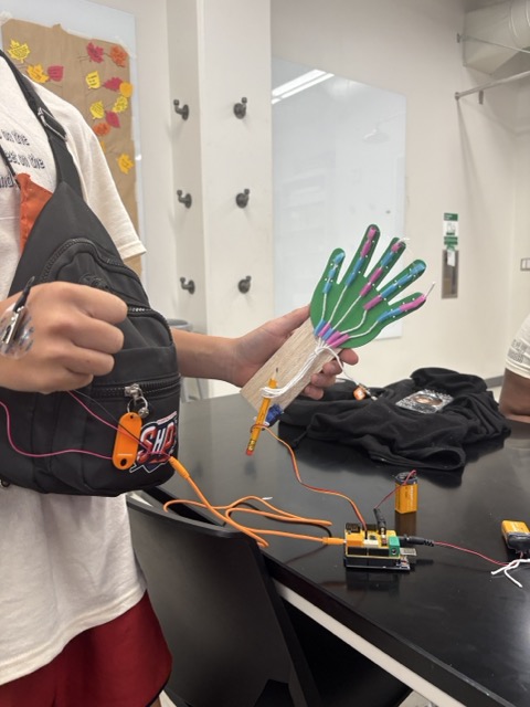 A student working with a prosthetic hand