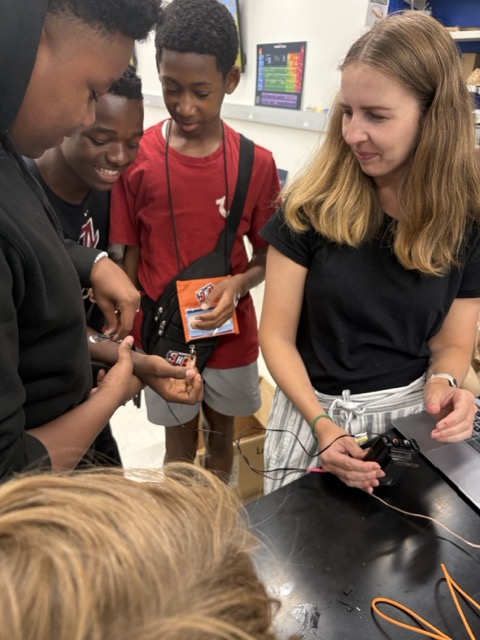 Students testing a prosthetic hand model