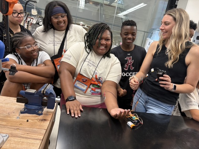 Students testing a prosthetic hand model