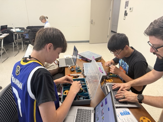 Students working with computers and micro:bits equipment