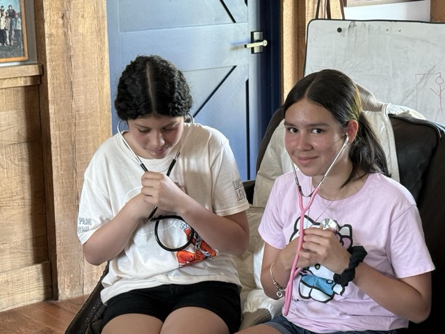 Students using stethoscopes 