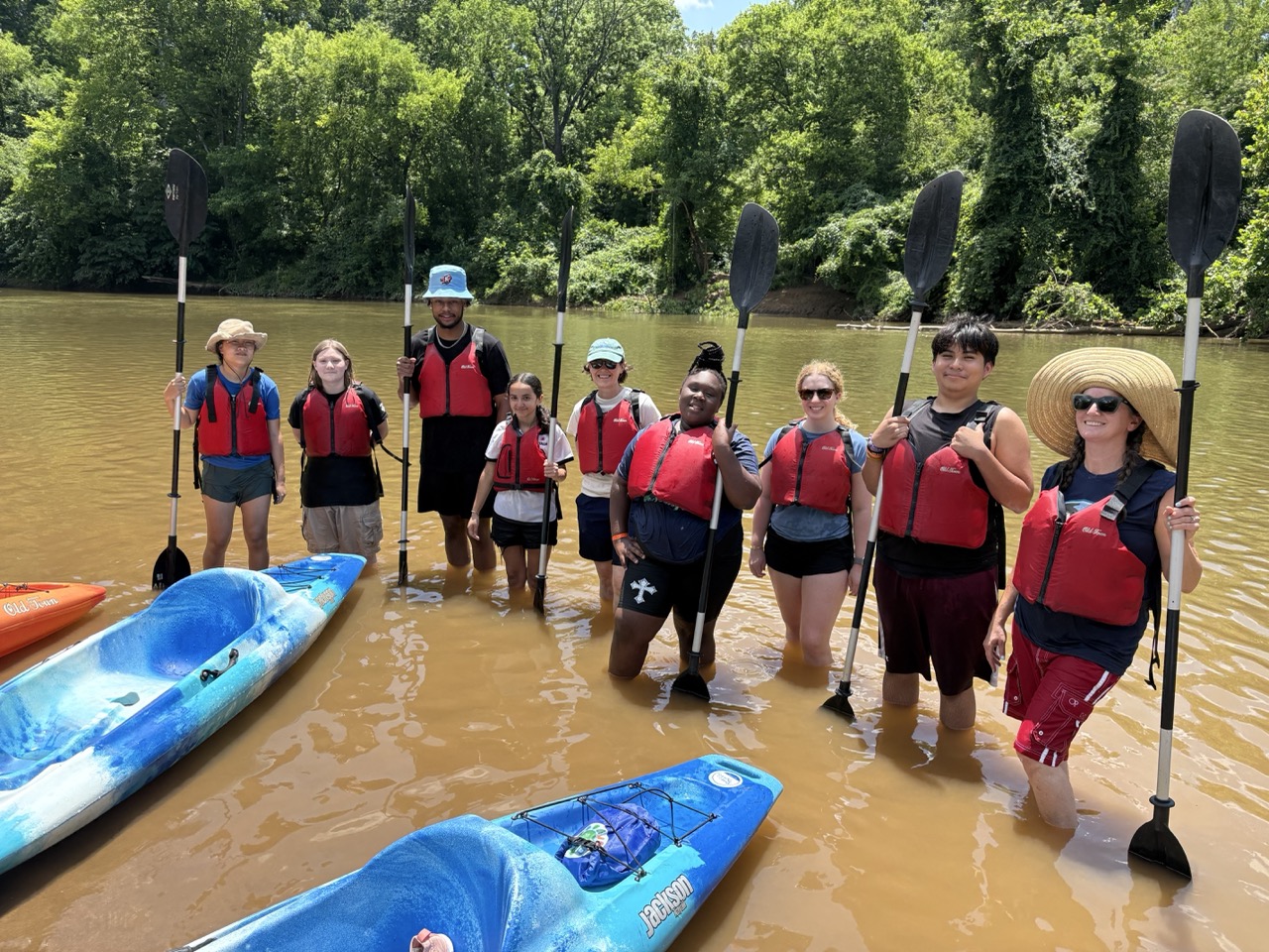 Students pose for a picture in the river