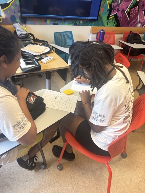 Students writing at a desk