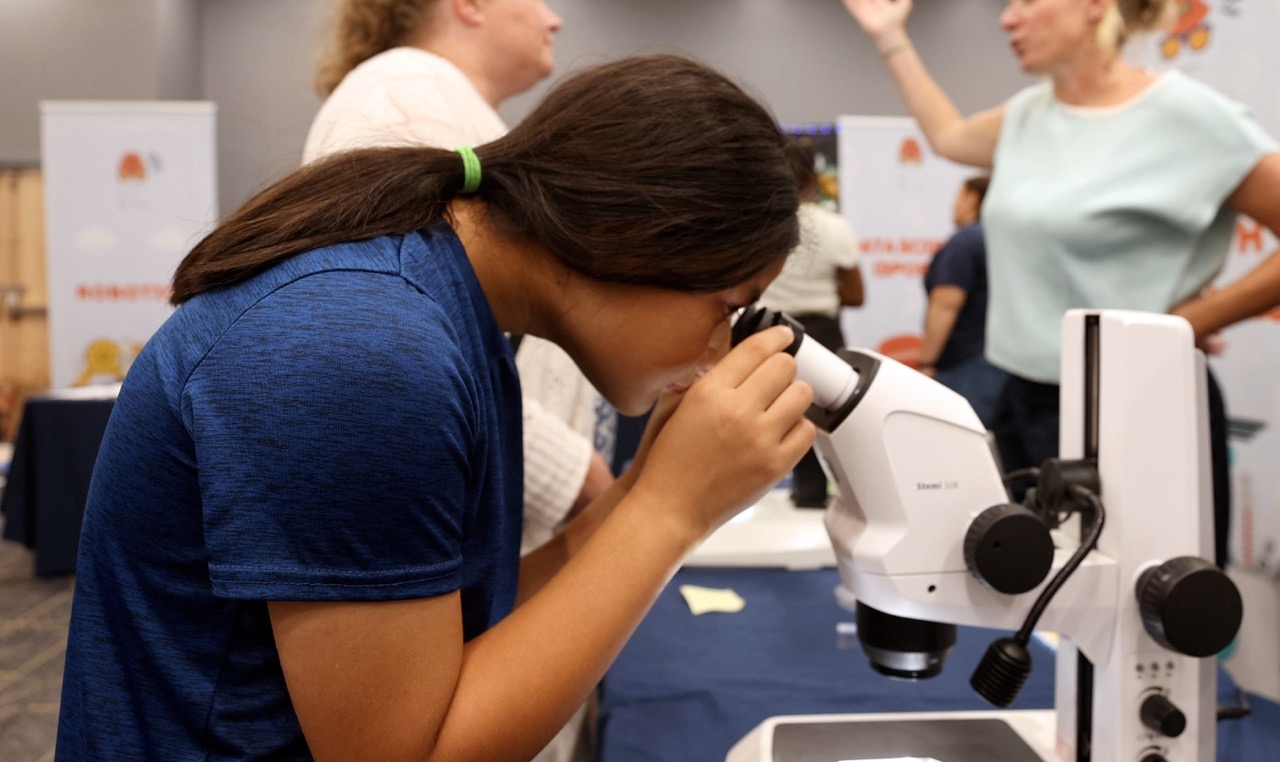 A student looking through a microscope