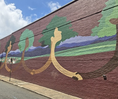 Charlottesville mural with stylized figures holding hands